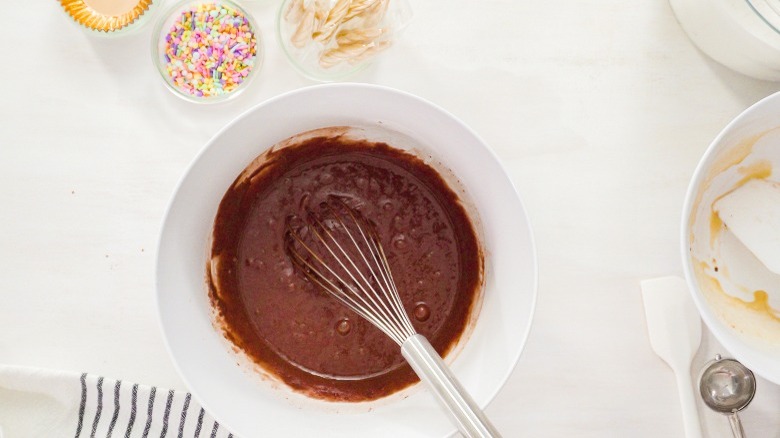 Bowl of chocolate frosting with whisk