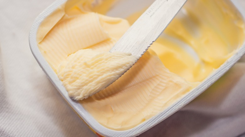 Knife in tub of margarine