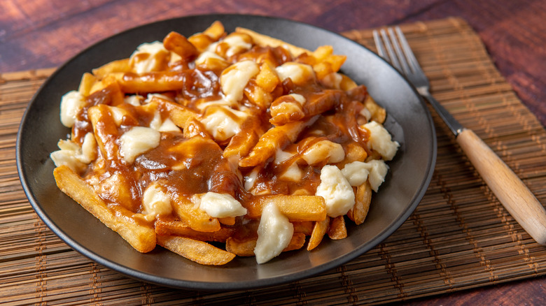 Plate of poutine on table