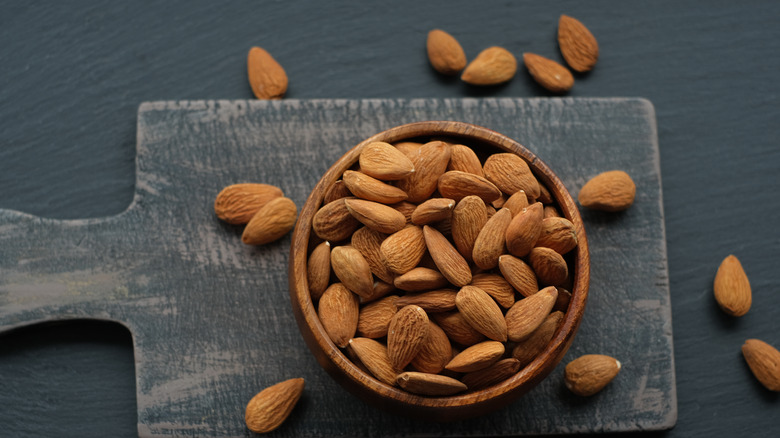 Bowl of almonds on cutting board