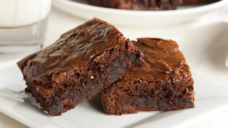 Two brownies stacked on plate