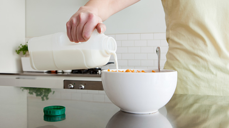 Pouring milk in cereal bowl