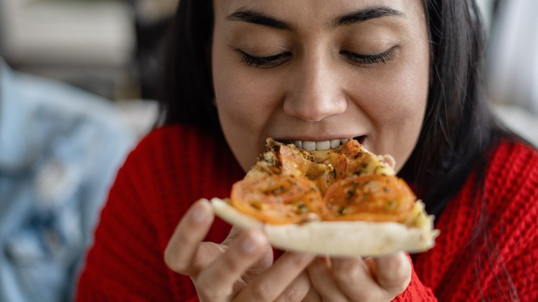 Woman eating pizza