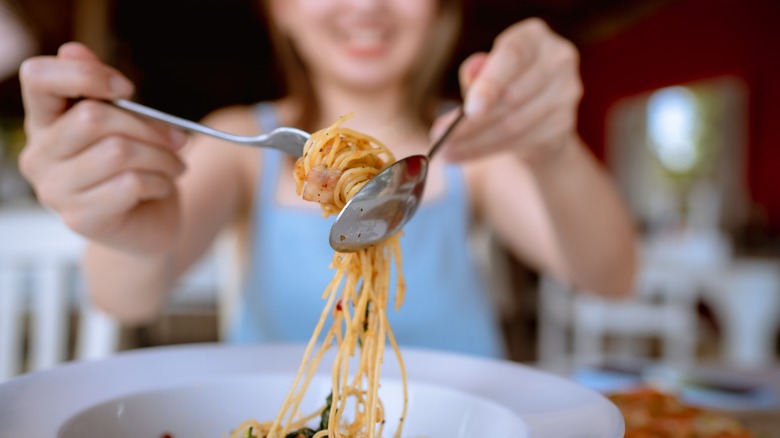 Woman twirling spaghetti