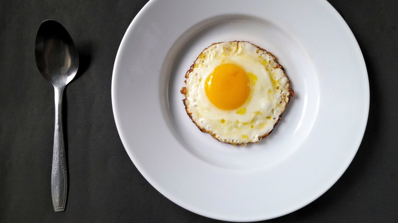 round fried egg on plate