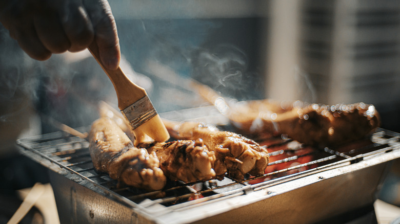 basting meat on grill