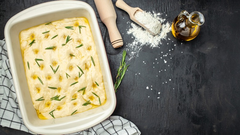 Oily focaccia dough in dish