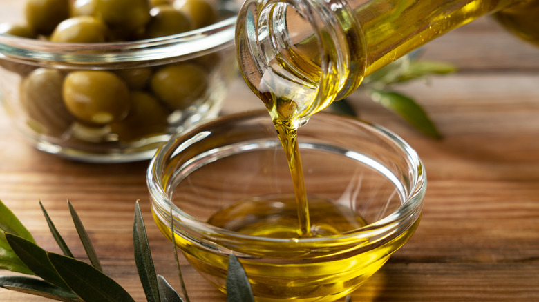 Olive oil pouring in bowl