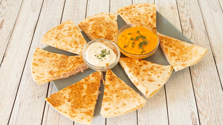 shredded chicken quesadilla pieces with dips