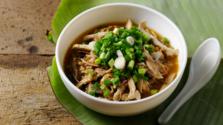 Thai shredded chicken soup with green onions