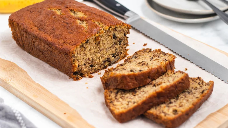 Sliced banana bread next to a knife