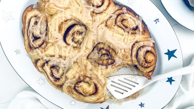 Top-down view of cinnamon rolls on a white plate