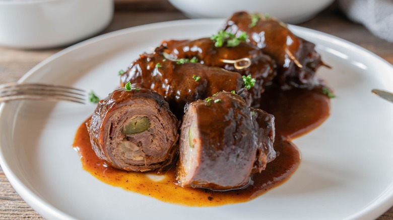 plate of german rouladen with gravy