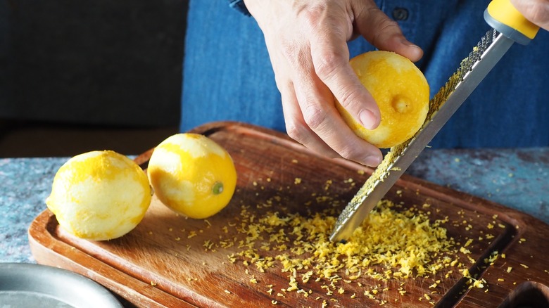 Person grating lemon zest