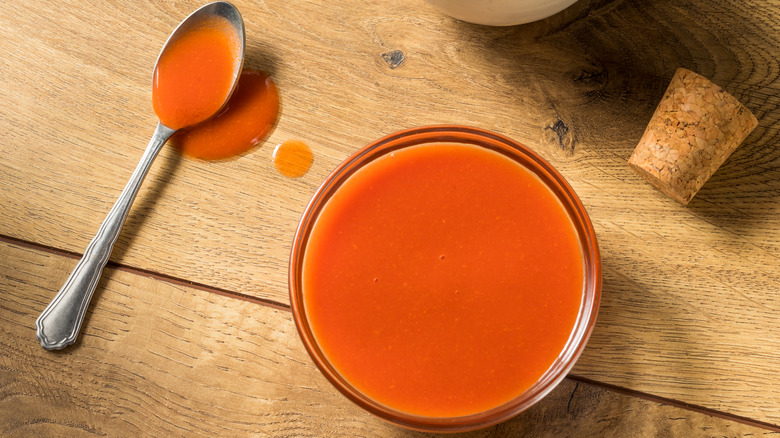 Bowl and spoon of hot sauce