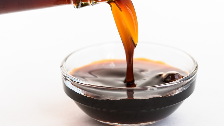 Pouring dark sauce into bowl