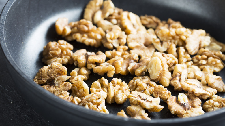 Walnuts toasting in pan