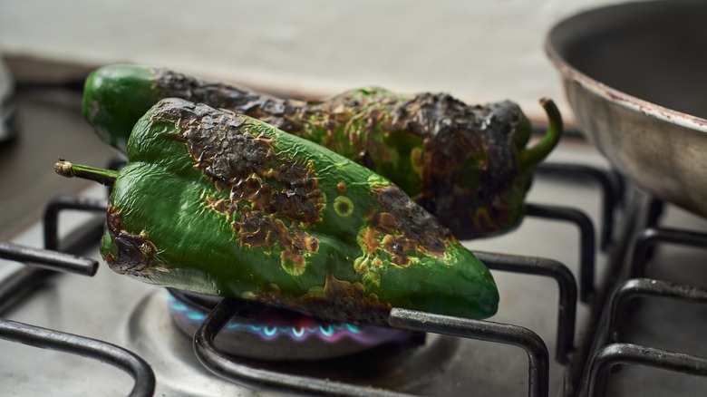 Cooking poblanos on open flame