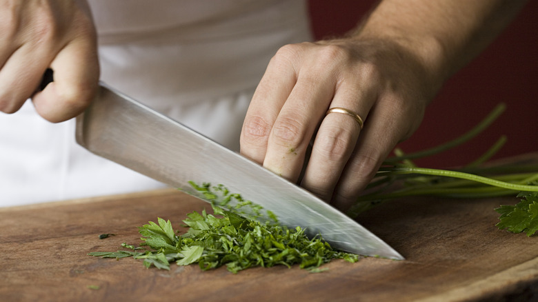 man chopping parsley