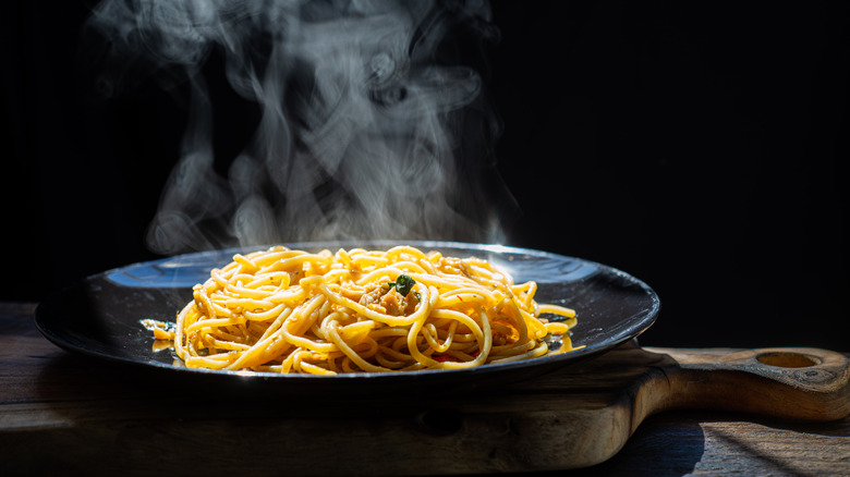 Steaming carbonara on wood board