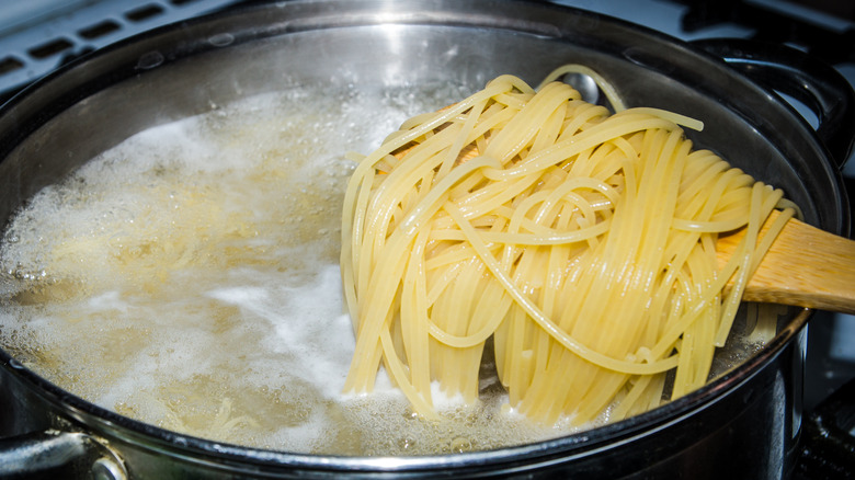 Removing cooked pasta from water