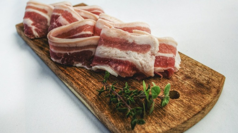 Sliced bacon on cutting board