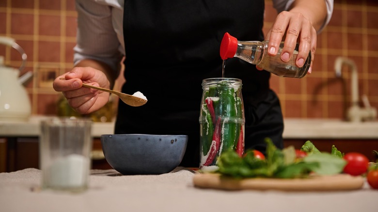 Person measuring home canning ingredients