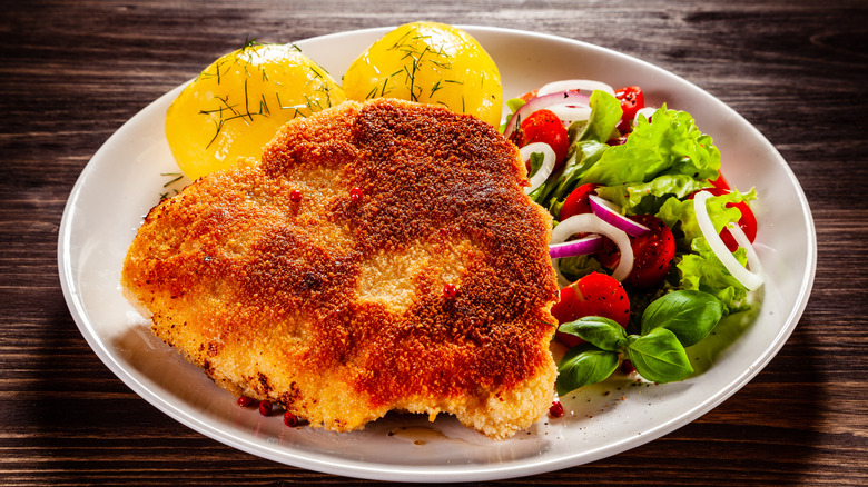 breaded pork chop on plate