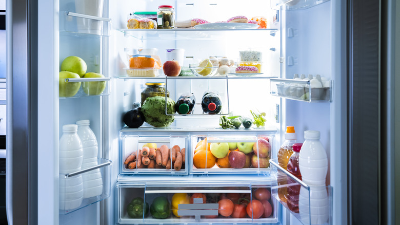 open fridge door with food