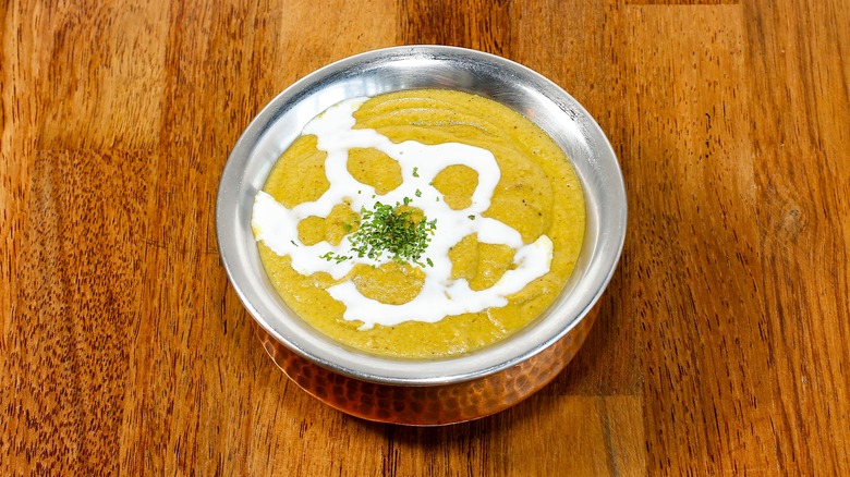 Bowl of korma drizzled with coconut cream