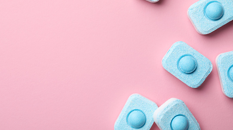 dishwasher tablets on pink background