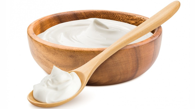 Wooden bowl of sour cream