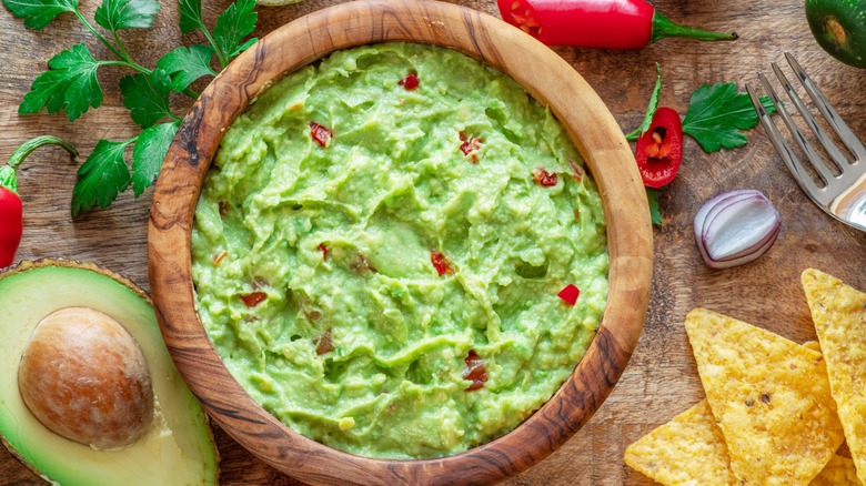 bowl of guacamole with chips