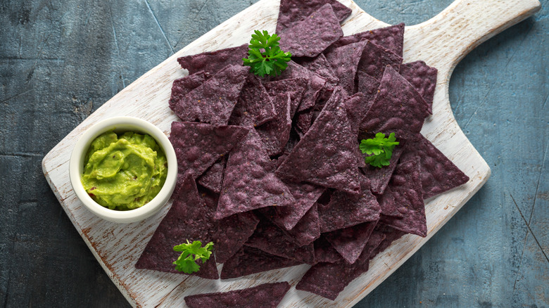 blue tortilla chips with guacamole