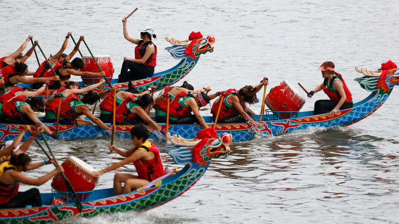 rowers in dragon-shaped boats