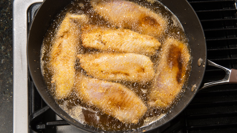 frying fish in pan