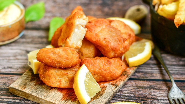 breaded fish on wooden board