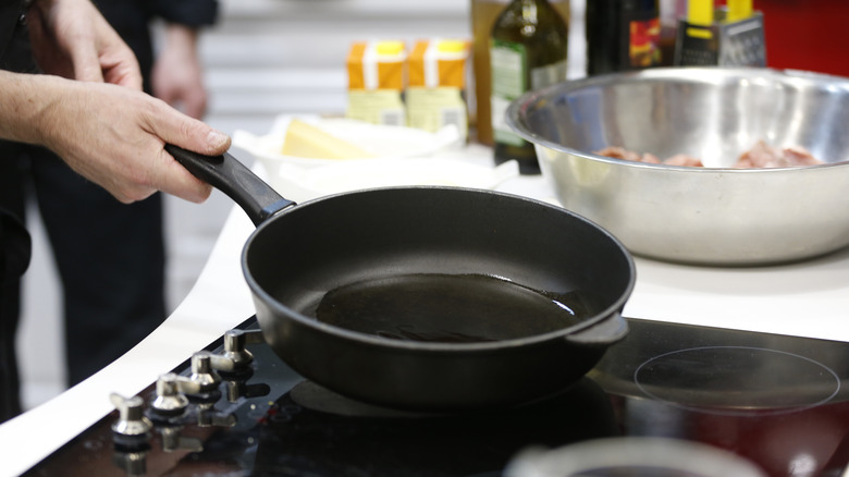 person holding pan with oil