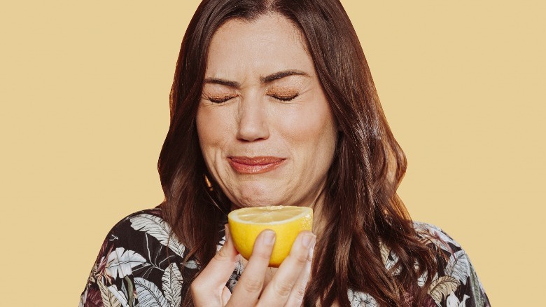 woman making face, sour lemon