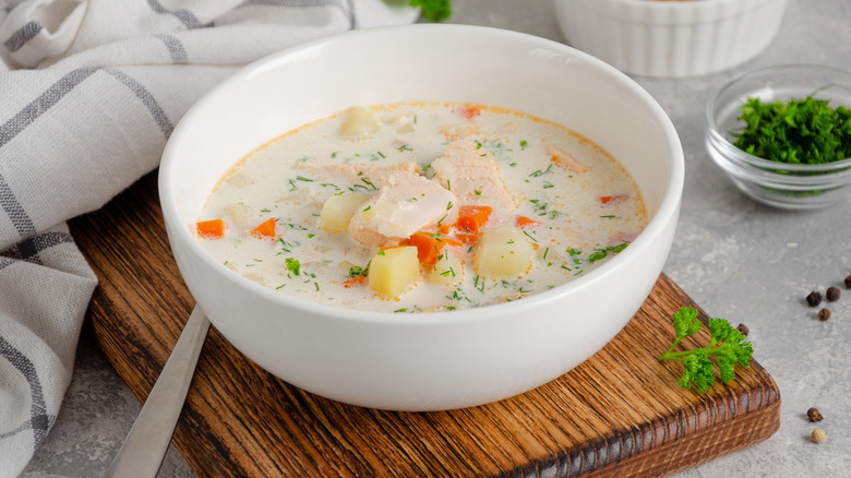 Salmon soup in white bowl