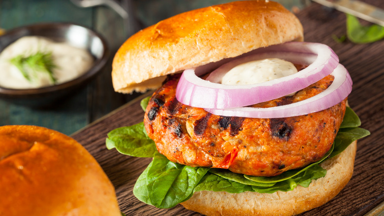 Salmon burger with lettuce and onion