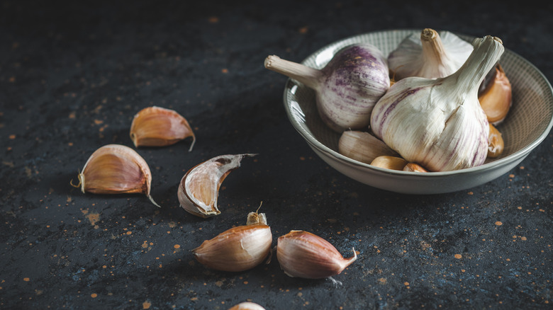 Garlic cloves on black counter