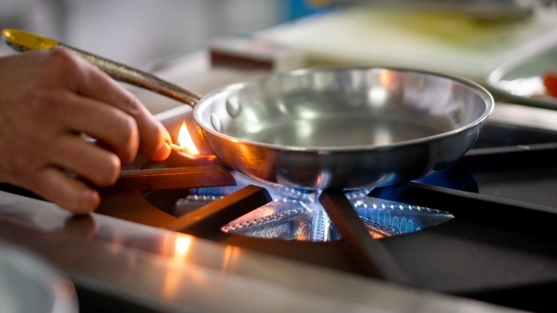 Pre-heating pan over gas