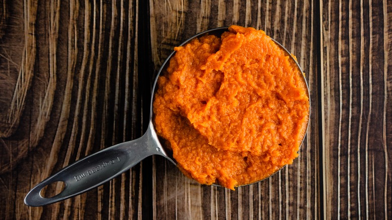 Pumpkin puree in measuring cup