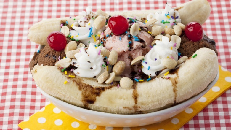 Banana split on white and red checkered tablecloth