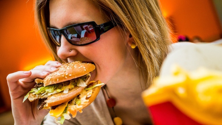 Woman biting into Big Mac