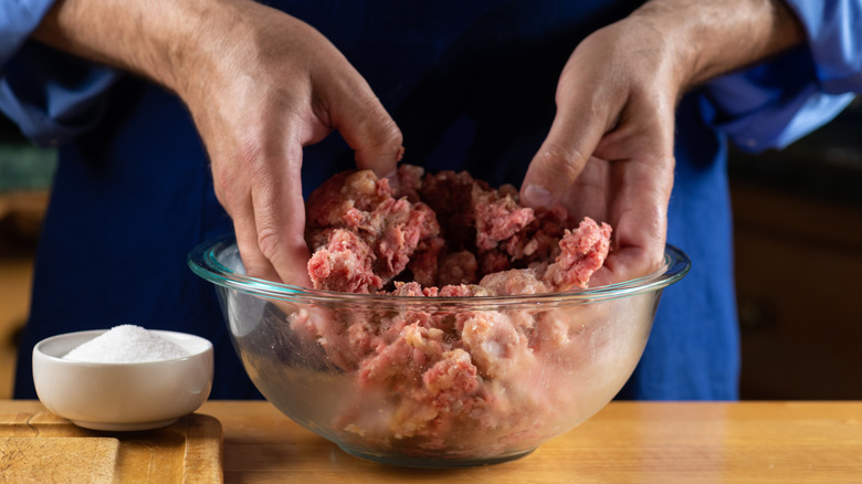 Hands mixing meatloaf