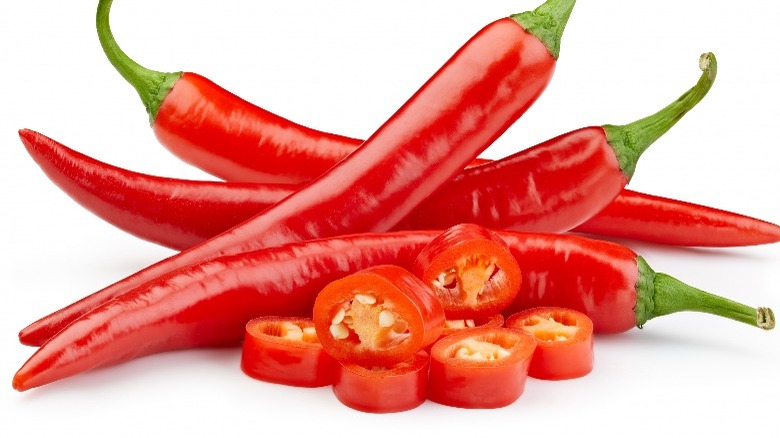 Whole and sliced red chili peppers