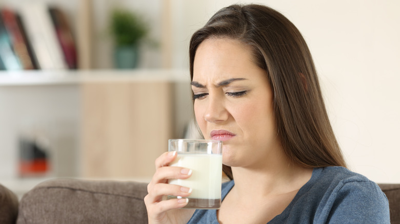 Woman smelling bad or curdled milk