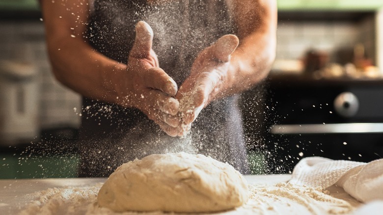 Close-up of person making dough